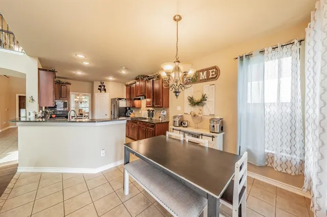 a view of kitchen and kitchen with granite countertop lots of counter top space