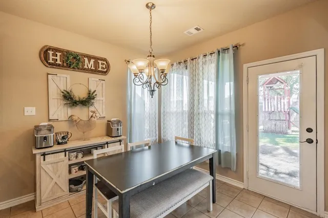 a view of a dining room with a table and chairs