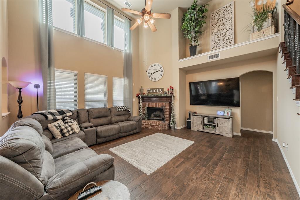 5112 Leeray Road Fort Worth, TX 76244 - Photo 14 of 34 a living room with furniture a flat screen tv and a fireplace