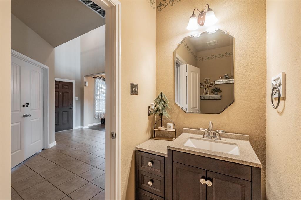 5112 Leeray Road Fort Worth, TX 76244 - Photo 6 of 34 a bathroom with a sink and a mirror