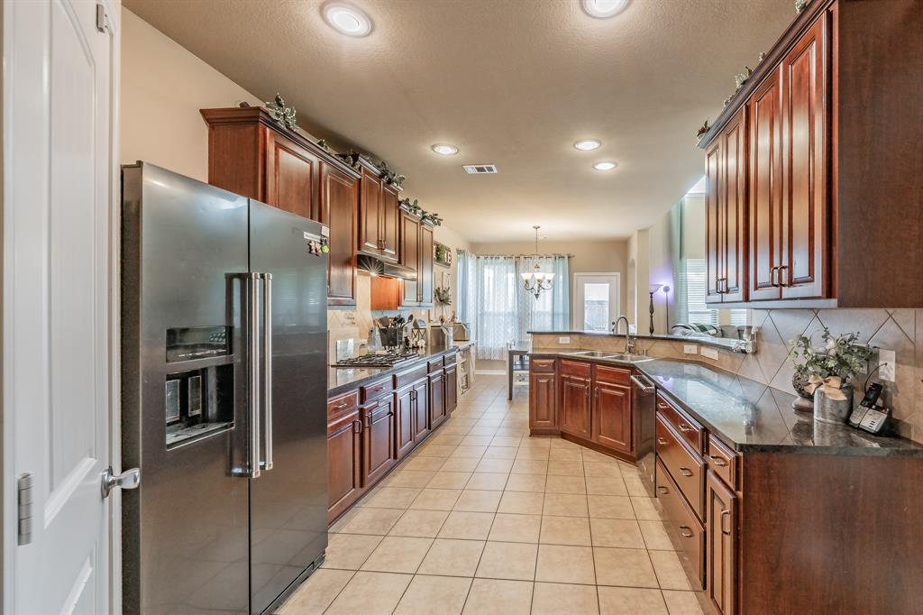 5112 Leeray Road Fort Worth, TX 76244 - Photo 7 of 34 a kitchen with stainless steel appliances granite countertop a sink stove and refrigerator