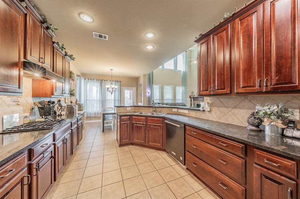 5112 Leeray Road Fort Worth, TX 76244 - Photo 8 of 34 a kitchen with stainless steel appliances granite countertop counter space a sink and cabinets