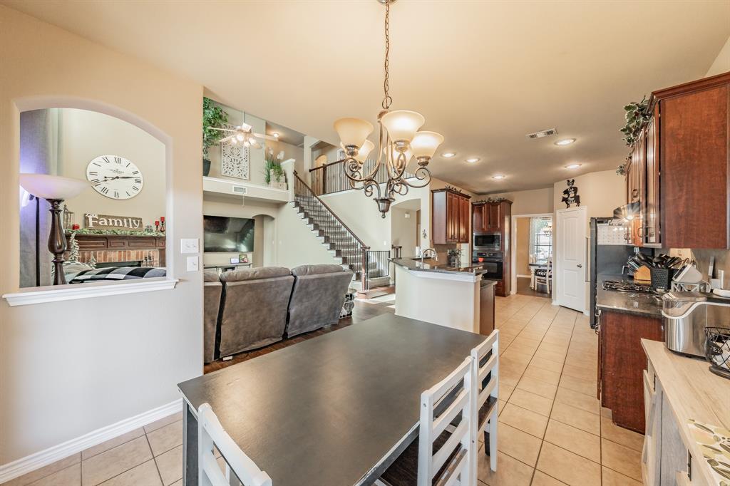 5112 Leeray Road Fort Worth, TX 76244 - Photo 10 of 34 a view of a kitchen and dining room with a table chairs