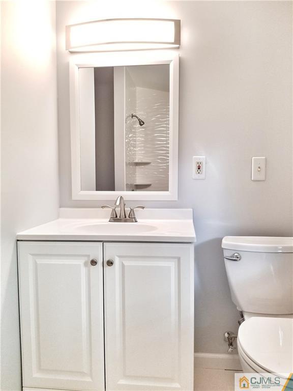 116 Emerson Road Somerset, NJ 08873 - Photo 13 of 22 a bathroom with a toilet a sink and mirror