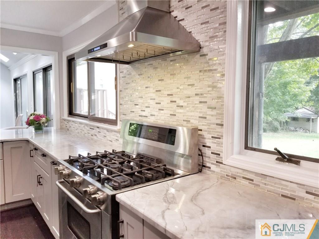 116 Emerson Road Somerset, NJ 08873 - Photo 18 of 22 a kitchen with stainless steel appliances a stove a sink and a refrigerator