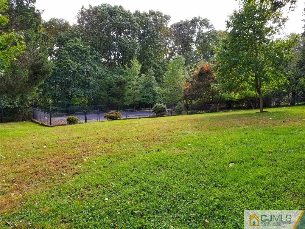 116 Emerson Road Somerset, NJ 08873 - Photo 21 of 22 a view of a green field with trees in the background