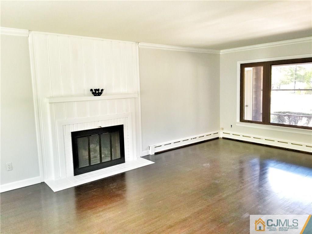 116 Emerson Road Somerset, NJ 08873 - Photo 4 of 22 a view of an empty room with a window and fireplace