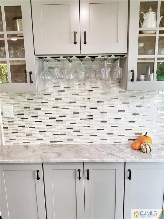 116 Emerson Road Somerset, NJ 08873 - Photo 7 of 22 a sink with a granite countertop white cabinets and a sink