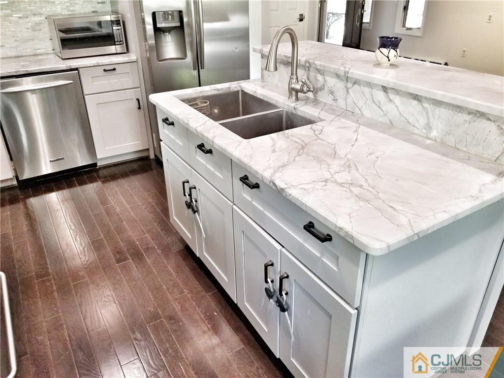 116 Emerson Road Somerset, NJ 08873 - Photo 8 of 22 a kitchen with granite countertop a white stove top oven and sink