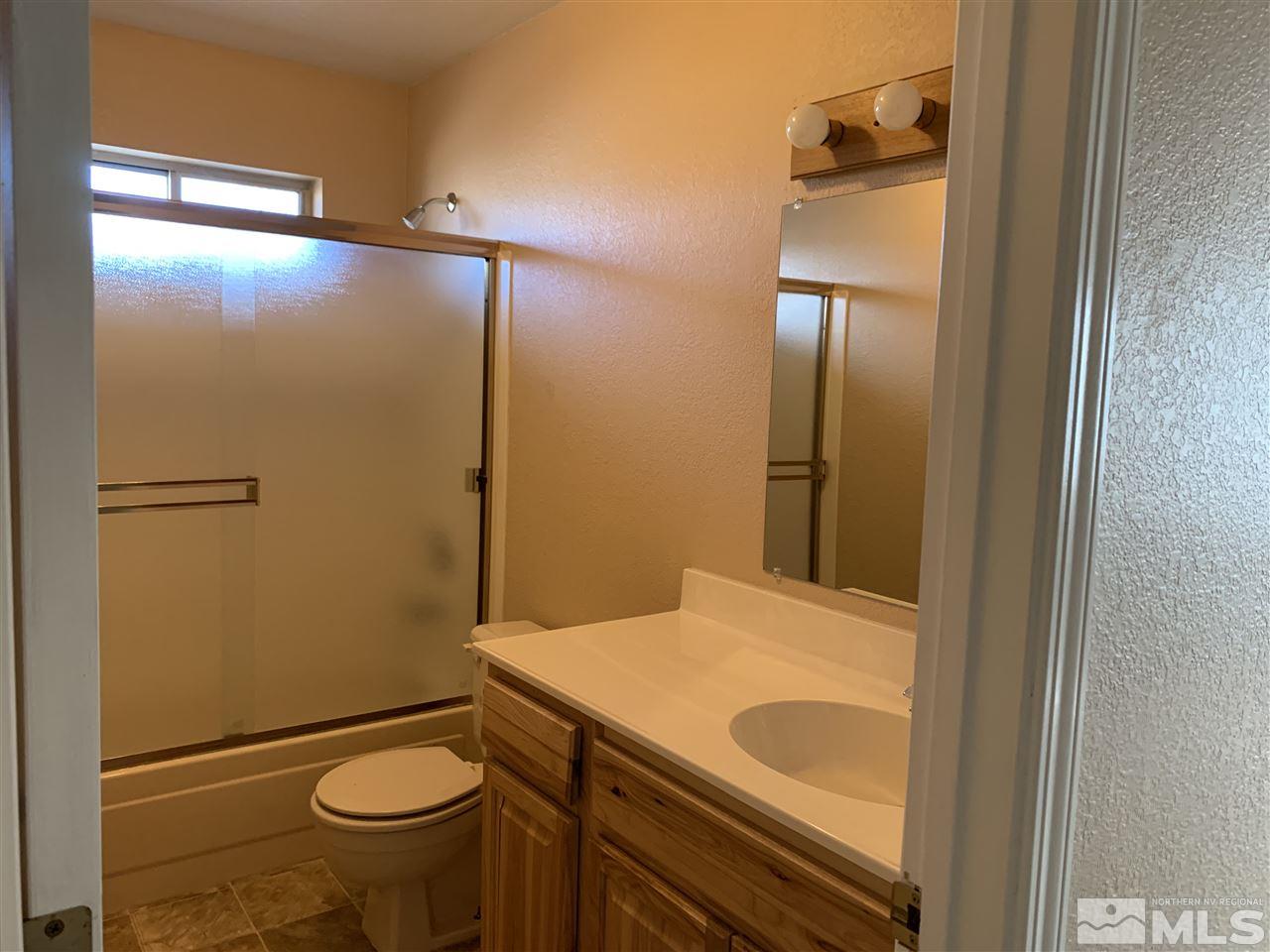100 Silverstone Place Reno, NV 89512 - Photo 12 of 17 a bathroom with a granite countertop sink toilet and shower