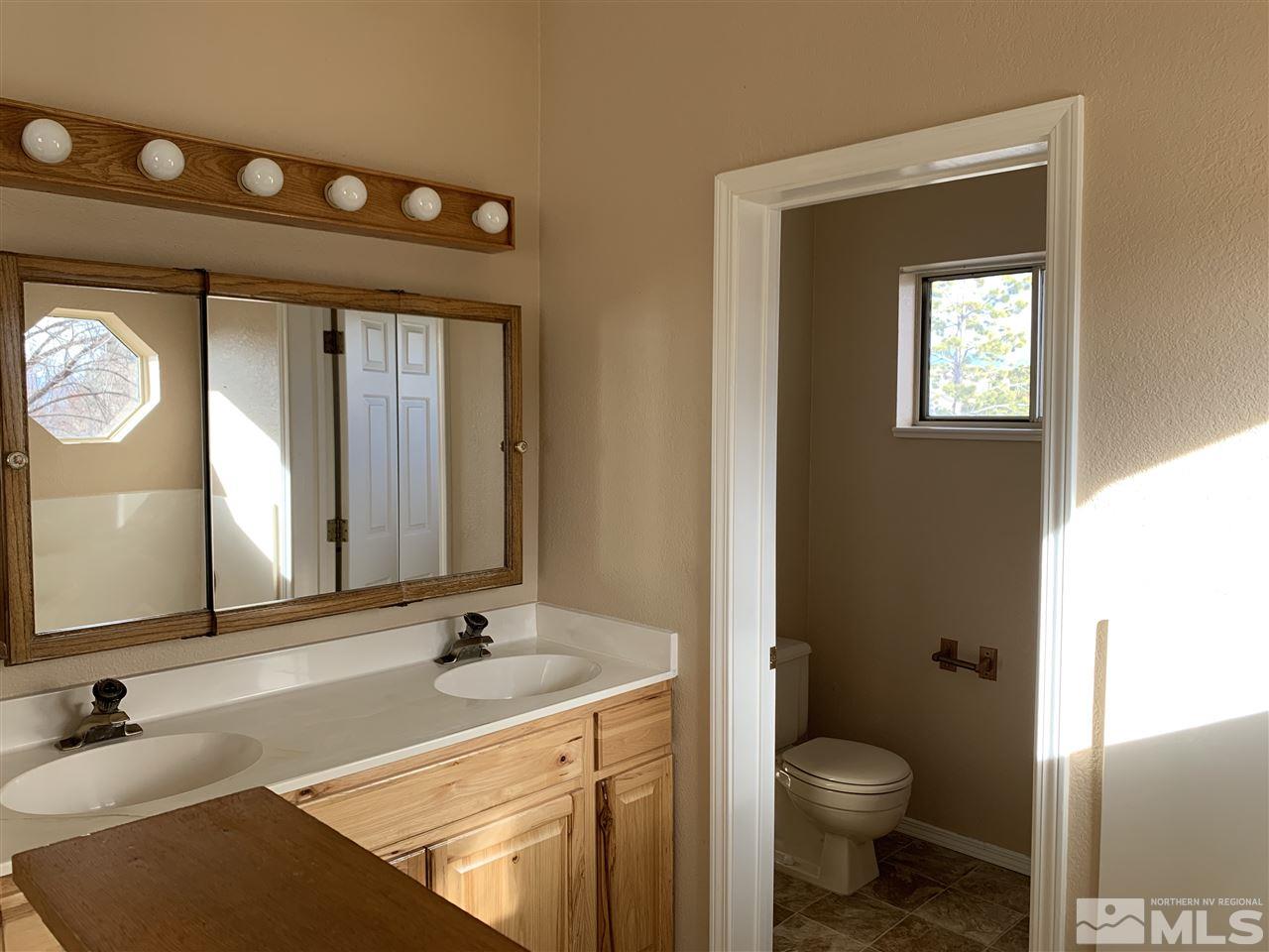 100 Silverstone Place Reno, NV 89512 - Photo 10 of 17 a bathroom with a sink a toilet and a mirror