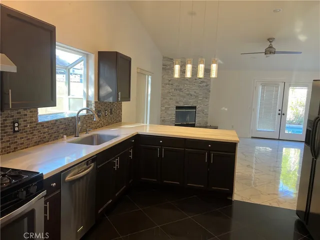 a kitchen with a sink and a stove top oven
