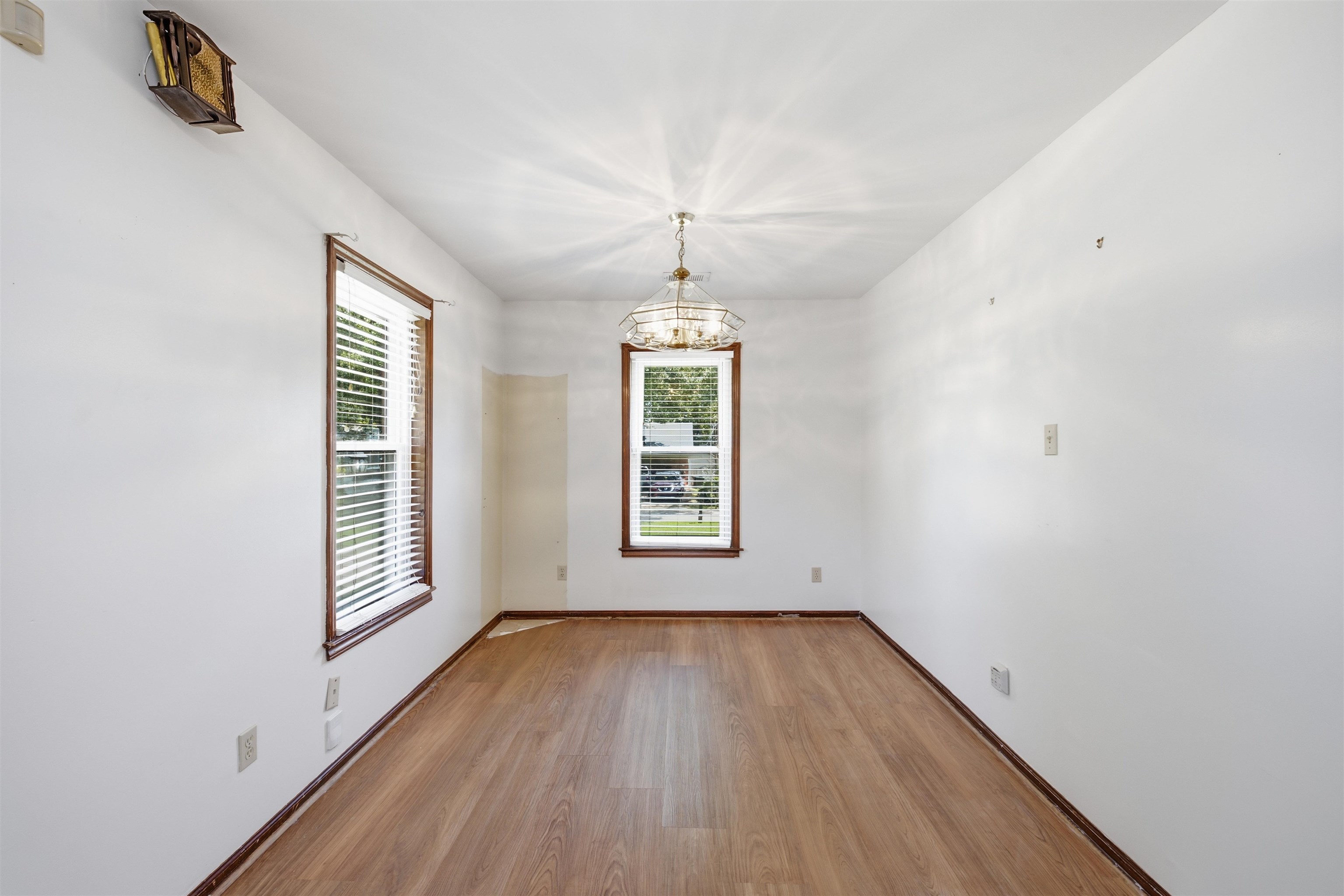 3007 Ruskin Road Bartlett, TN 38134 - Photo 10 of 37 Bright interior space featuring wood-finish flooring, white walls, and a ceiling-mounted light fixture