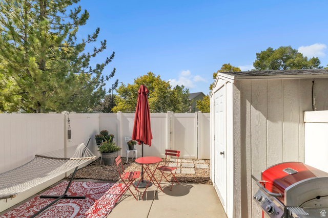 814 North 175 East Springville, UT 84663 - Photo 14 of 18 Fenced backyard with grilling area, a patio, and a storage shed