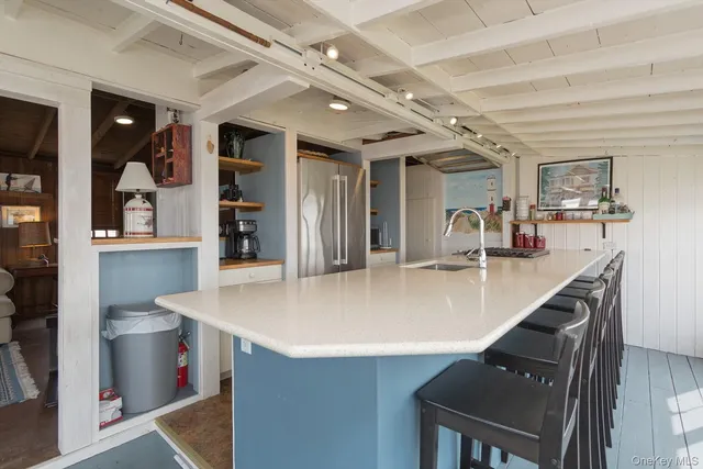 a view of kitchen island with stainless steel appliances refrigerator stove and microwave