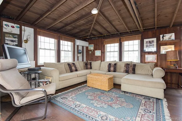 a living room with furniture a wooden floor and a chandelier