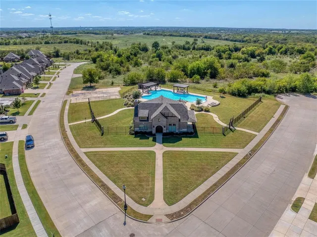 an aerial view of a house with swimming pool and outdoor seating
