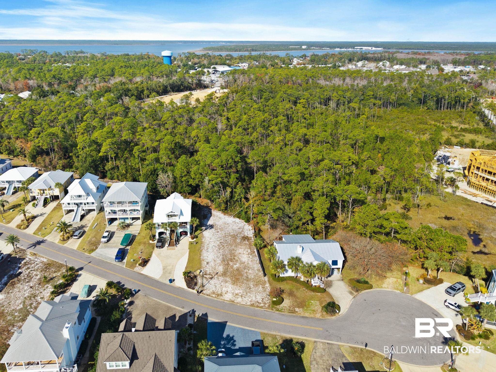 4143 Harbor Road Orange Beach, AL 36561 - Photo 14 of 33 Aerial view of property's location featuring nearby suburban area and a large body of water