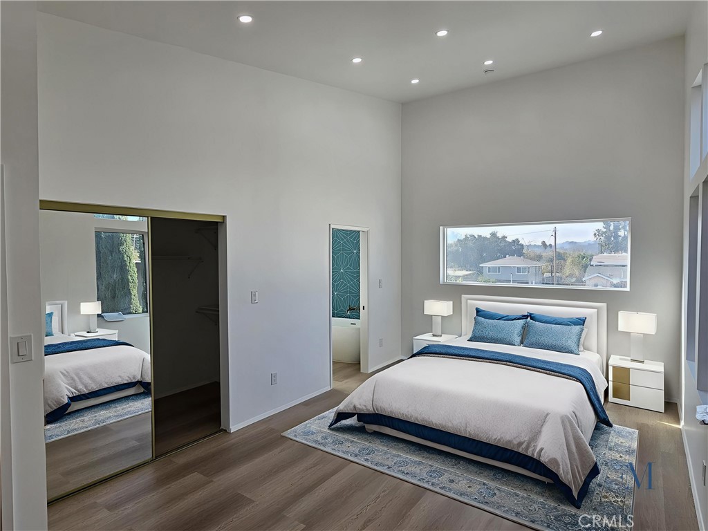 720 San Pascual Avenue Los Angeles, CA 90042 - Photo 15 of 20 a bedroom with a large bed and a walk in closet