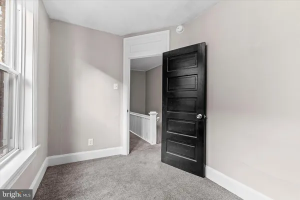 a view of a hallway with wooden floor and entryway