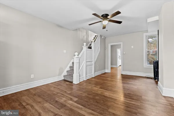 wooden floor in an empty room with a window