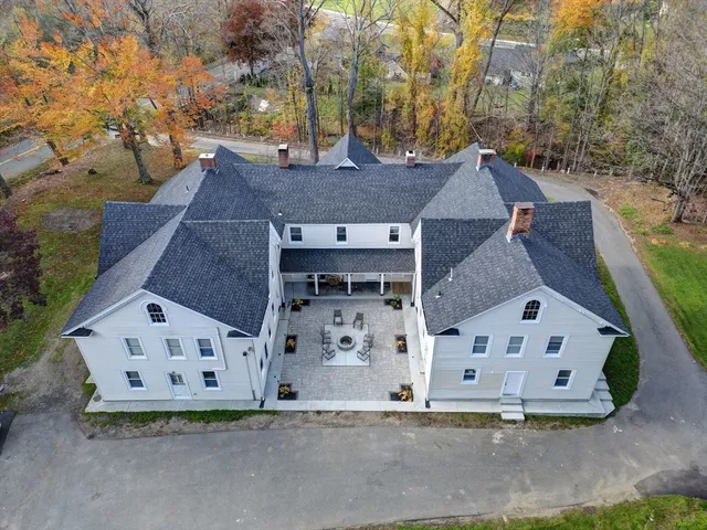 an aerial view of a house with a yard