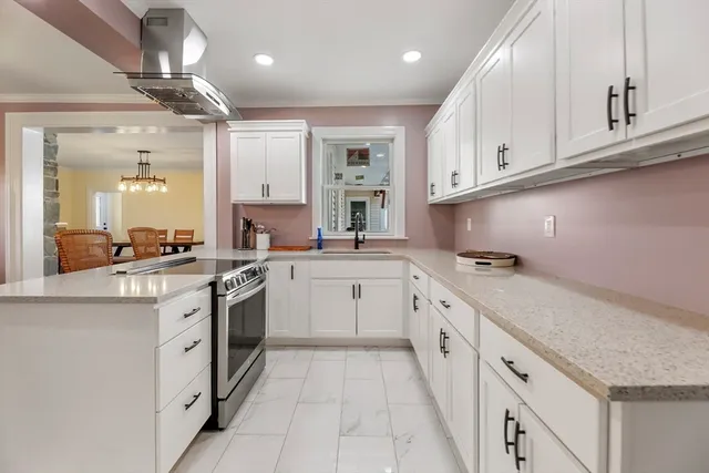 a kitchen with granite countertop white cabinets and white appliances