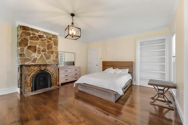 a spacious bedroom with a bed and a window