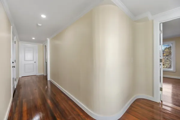 a view of hallway with wooden floor