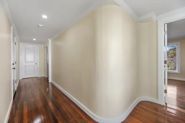 a view of hallway with wooden floor
