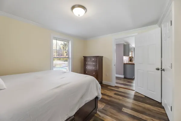 a bedroom with a bed and a dresser