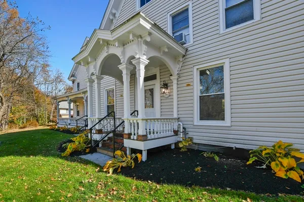 a view of a house with backyard and sitting area