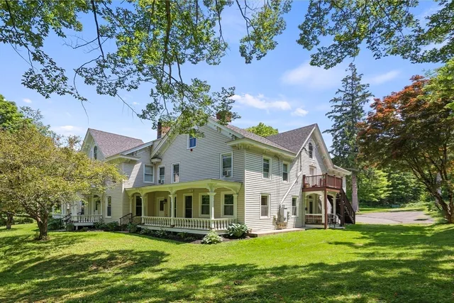 a front view of a house with a garden