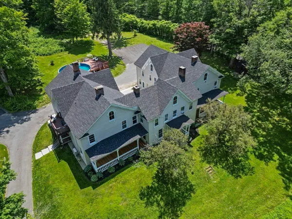 an aerial view of a house with swimming pool outdoor seating and yard