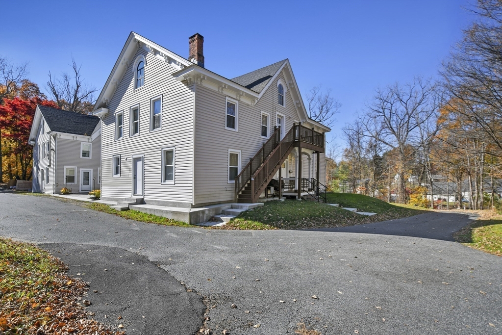 45 Forest Street Lee, MA 01238 - Photo 4 of 42 a view of a white house with a big yard and large trees