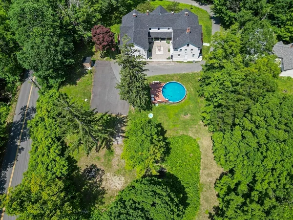 an aerial view of a house with a yard