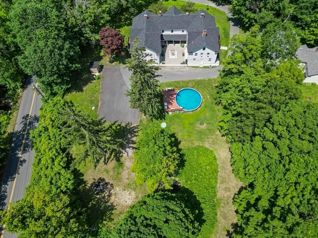 an aerial view of a house with a yard