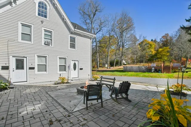 a view of a house with a swimming pool and sitting area