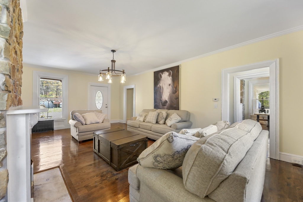 45 Forest Street Lee, MA 01238 - Photo 9 of 42 a living room with furniture chandelier and a window