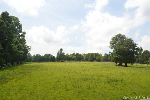 405 Shuping Mill Road Salisbury, NC 28146 - Photo 22 of 24 a view of a field with an trees in the background