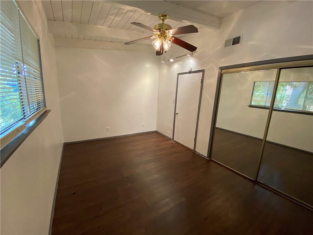2413 Leon Street, Unit 102 Austin, TX 78705 - Photo 13 of 22 en empty room with wooden floor and fan