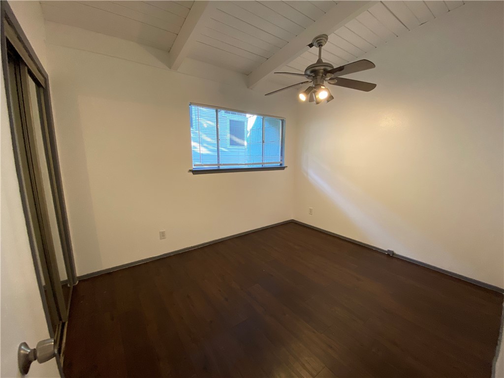 2413 Leon Street, Unit 102 Austin, TX 78705 - Photo 17 of 22 an empty room with wooden floor fan and window