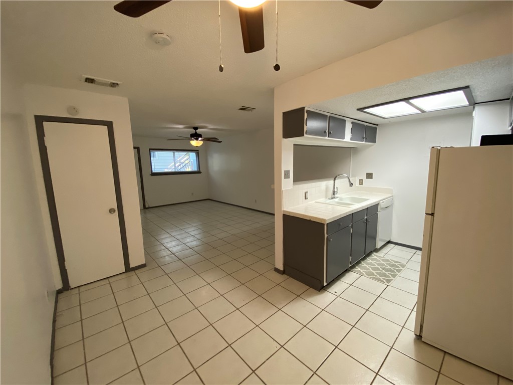 2413 Leon Street, Unit 102 Austin, TX 78705 - Photo 2 of 22 a bathroom with a sink a mirror and shower