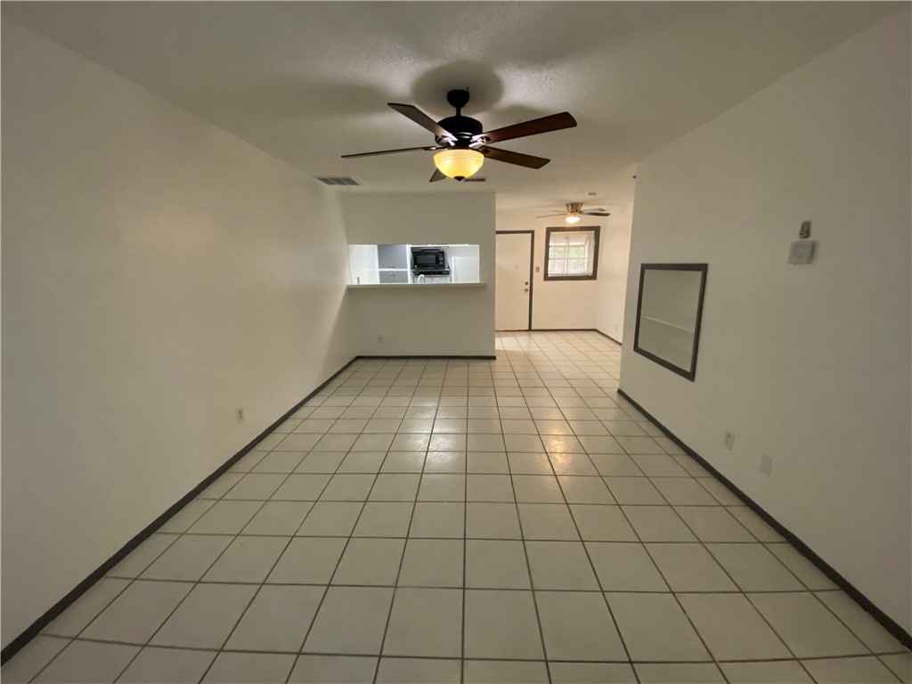 2413 Leon Street, Unit 102 Austin, TX 78705 - Photo 6 of 22 a view of a livingroom with a ceiling fan and window