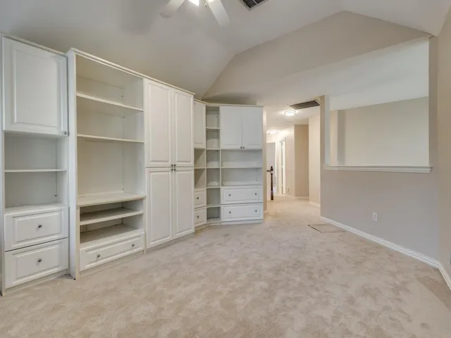 a view of an empty room with a closet