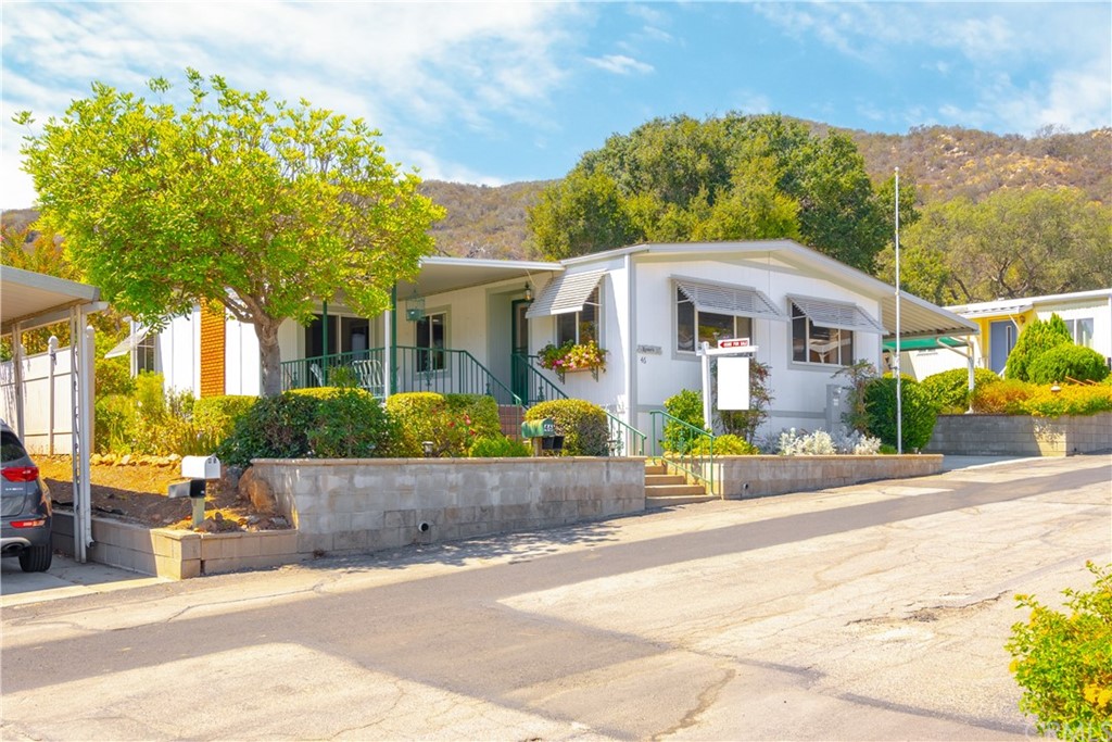 4747 Oak Crest Road, Unit 46 Fallbrook, CA 92028 - Photo 1 of 1 a front view of a house with a garden