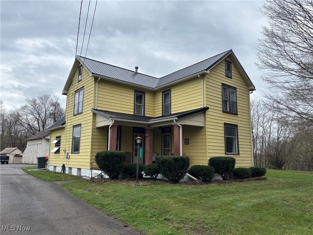 6380 Old River Road Philo, OH 43771 - Photo 1 of 26 Traditional-style house with a front yard, an outdoor structure, and brick siding