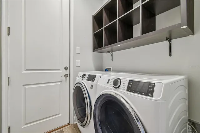 a kitchen with stainless steel appliances a sink a stove a microwave and wooden floor