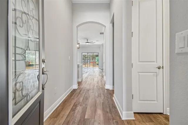 a view of an empty room with window and closet area