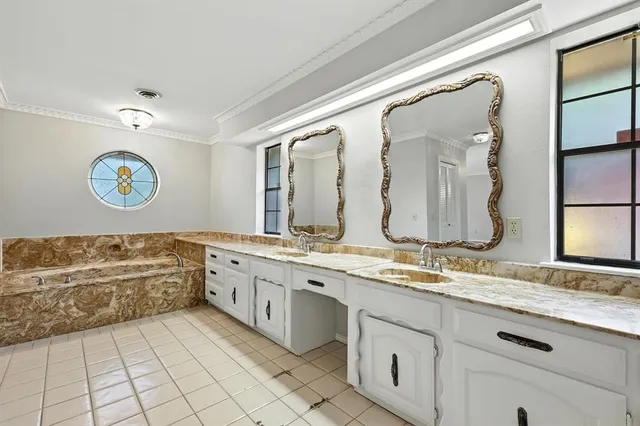 a spacious bathroom with a granite countertop sink mirror and a